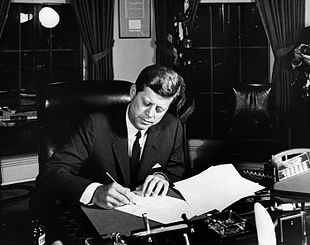 310px-october_23_1962-_president_kennedy_signs_proclamation_3504_authorizing_the_naval_quarantine_of_cuba